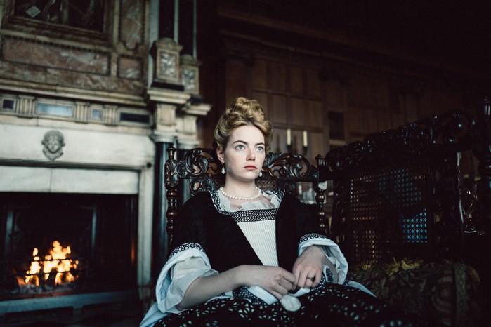 Emma Stone sat down in 18th century dress in The Favourite