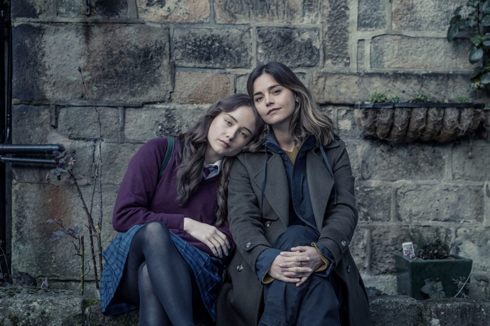 Ruby Stokes as Hannah and Jenna Coleman as Ember in The Jetty sitting together resting their heads together and looking into camera