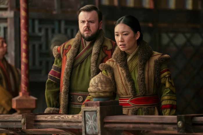 John Bradley as Jack Rooney and Jess Hong as Jin Cheng standing at a balcony and looking out in 3 Body Problem.