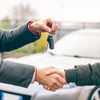 italy,Lombardy,Milan. Two people reaching an agreement about a car sale.Concept about people and transportation