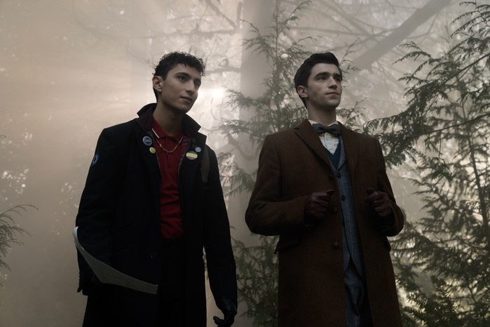 Jayden Revri as Charles Rowland and George Rexstrew as Edwin Payne in Dead Boy Detectives standing in a forest as the sun sets