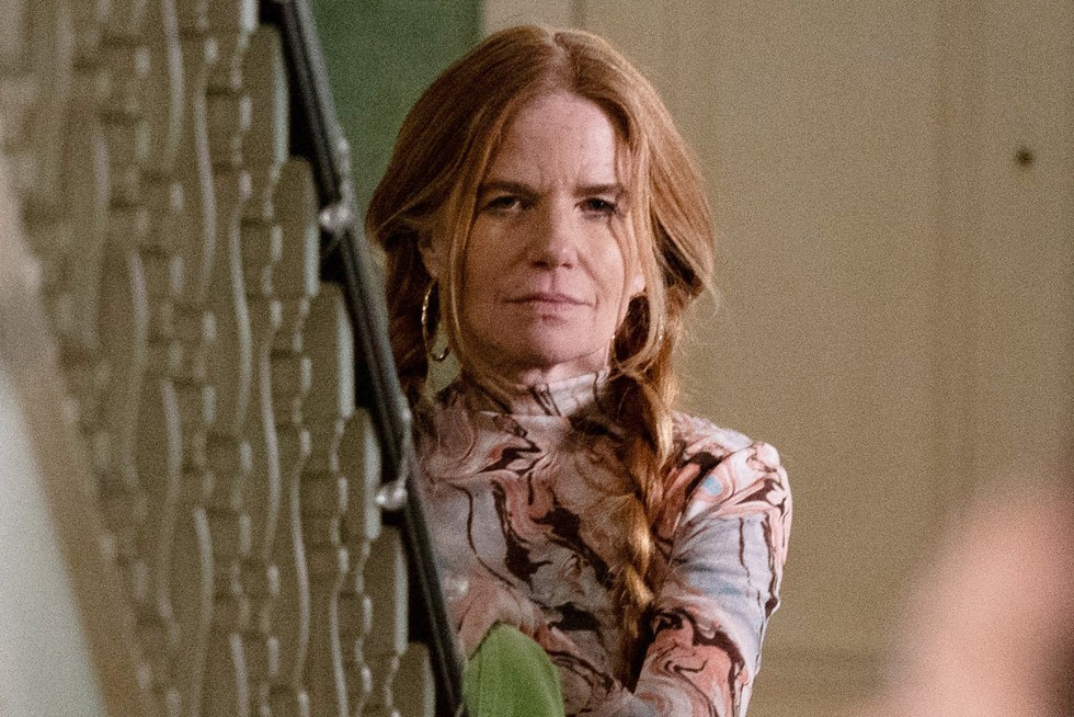 Patsy Palmer as Bianca Jackson scowling for EastEnders standing at the bottom of some stairs