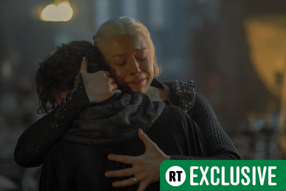 Emma D'Arcy as Rhaenyra Targaryen in House of the Dragon hugging a boy with RT Exclusive in the bottom right of the frame