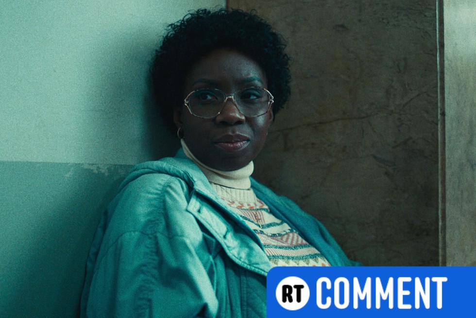 Adepero Oduye as Cecile sitting on a bench in the police station and leaning against the wall, looking to the side.