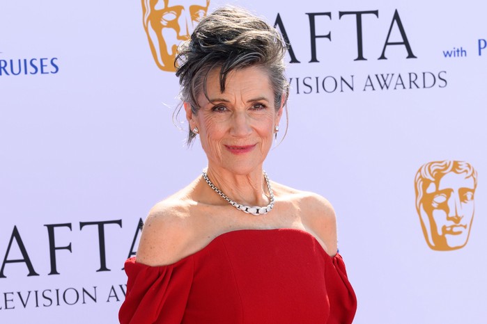 Harriet Walter in a red dress on the BAFTA red carpets