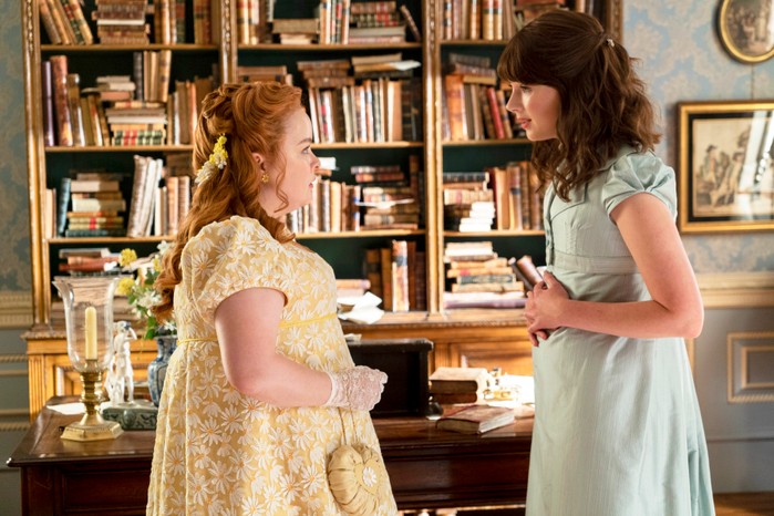 Eloise and Penelope standing facing one another, having a conversation