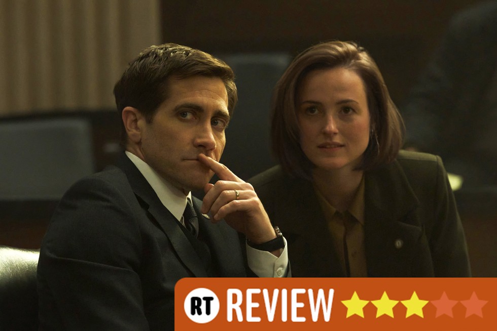 Jake Gyllenhaal and Renate Reinsve in Presumed Innocent, sat next to each other, looking at something off screen. There is an RT Review banner in the bottom right corner with three stars.