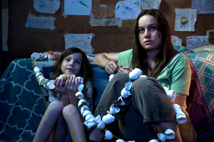 Brie Larson as Ma and Jacob Tremblay as Jack in Room, sat together on the floor