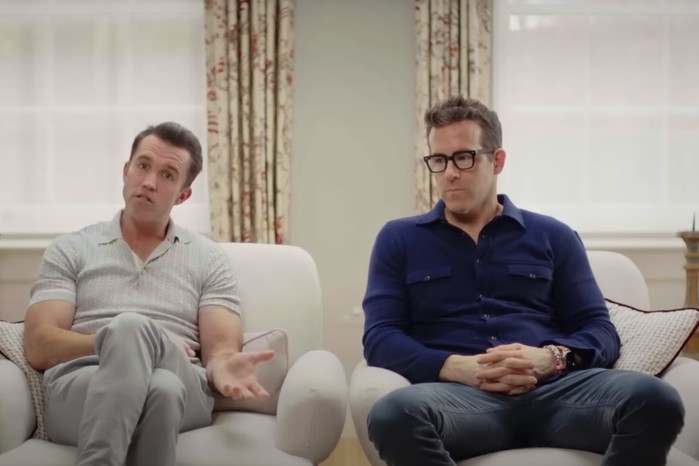 Ryan Reynolds and Rob McElhenney in Welcome to Wrexham season 3, sat in a room and talking to the camera