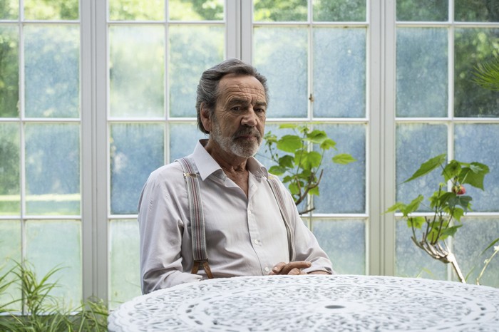 Robert Lindsay as Franklin Warner in Sherwood, sat at a table in a conservatory