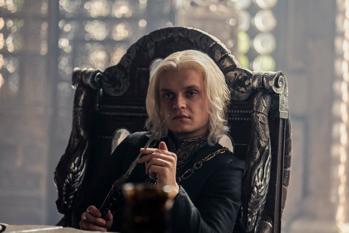 Tom Glynn-Carney sits in a throne as King Aegon II Targaryen in House of the Dragon season 2.